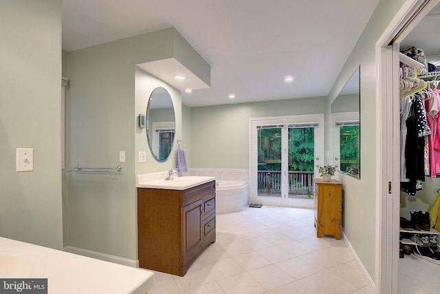 2119 Saint Heather Ln, Gambrills, MD 21054 - bathroom with vanity, tile patterned flooring, a walk in closet, a tub, and recessed lighting