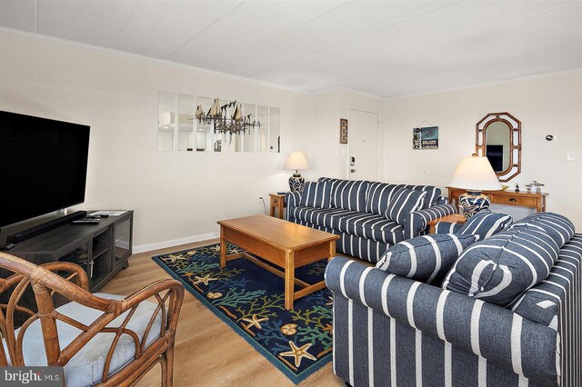 3801 Atlantic Ave Unit 517, Ocean City, MD 21842 - living room featuring wood finished floors, a chandelier, and crown molding