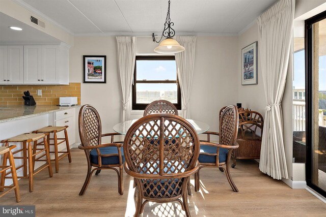 3801 Atlantic Ave Unit 517, Ocean City, MD 21842 - dining room featuring light wood-style floors, ornamental molding, and recessed lighting