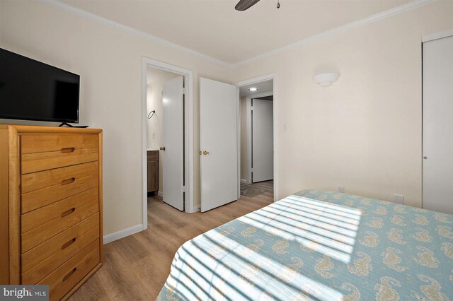 3801 Atlantic Ave Unit 517, Ocean City, MD 21842 - bedroom featuring light wood-style floors, crown molding, baseboards, and ensuite bath