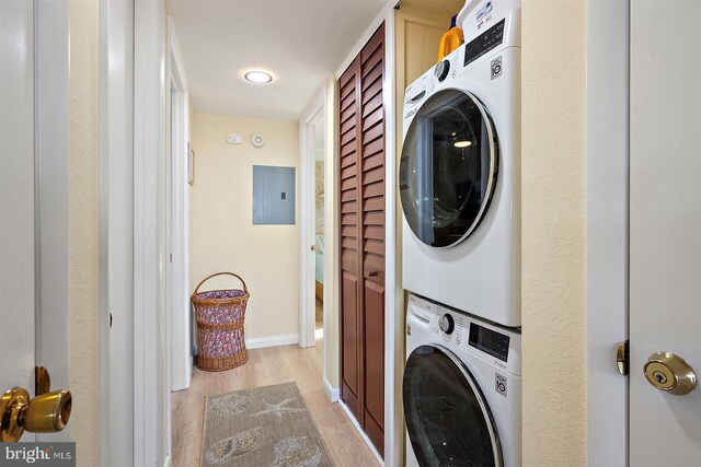 3801 Atlantic Ave Unit 517, Ocean City, MD 21842 - washroom with stacked washing machine and dryer, light wood-type flooring, electric panel, and baseboards