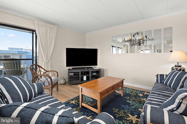 3801 Atlantic Ave Unit 517, Ocean City, MD 21842 - living area featuring wood finished floors, crown molding, a chandelier, and baseboards
