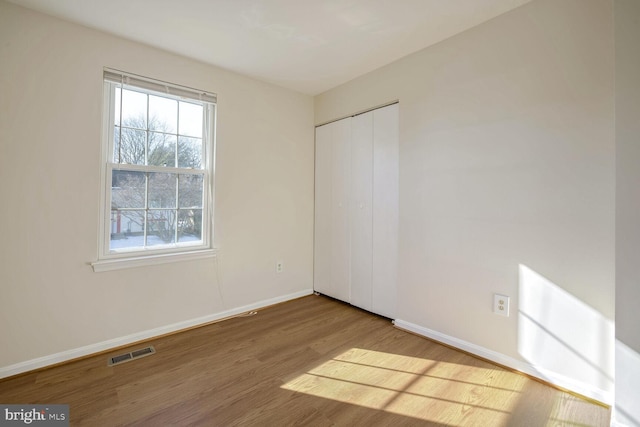 1 Ridge Heights Ct, Gaithersburg, MD 20879 - unfurnished bedroom with multiple windows, wood finished floors, baseboards, and a closet