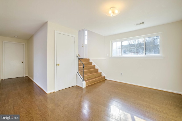 1 Ridge Heights Ct, Gaithersburg, MD 20879 - spare room with wood finished floors, baseboards, and stairway