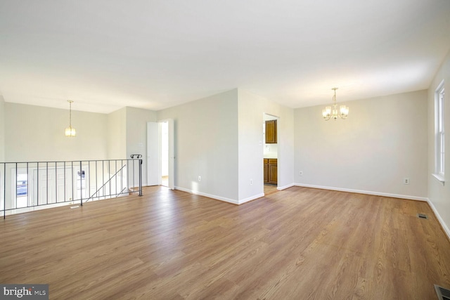 1 Ridge Heights Ct, Gaithersburg, MD 20879 - spare room featuring a chandelier, light wood-style floors, and baseboards