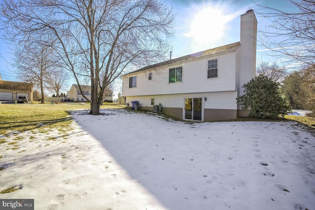 1 Ridge Heights Ct, Gaithersburg, MD 20879 - snow covered rear of property with a chimney and cooling unit