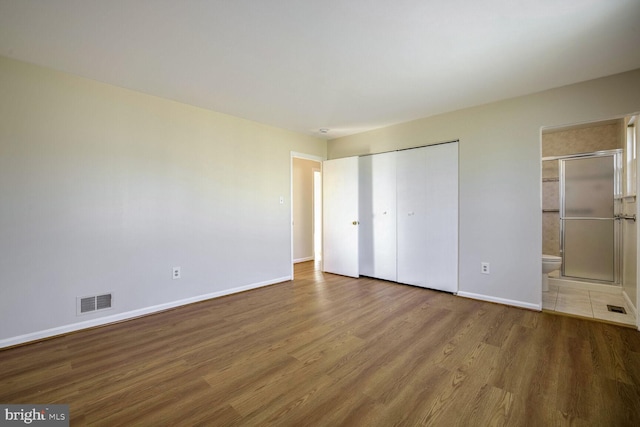 1 Ridge Heights Ct, Gaithersburg, MD 20879 - unfurnished bedroom featuring wood finished floors, baseboards, ensuite bath, and a closet