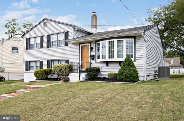355 Maple Ave, Gloucester City, NJ 08030 - split level home with central AC unit and a chimney