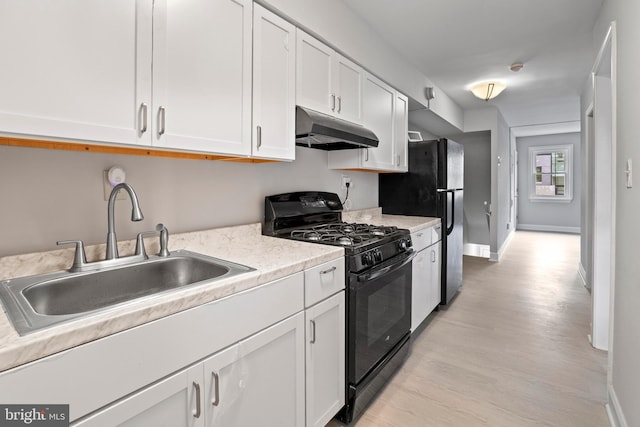 1731 Holbrook St NE, Washington, DC 20002 - kitchen featuring black range with gas stovetop, under cabinet range hood, a sink, white cabinetry, and light wood finished floors