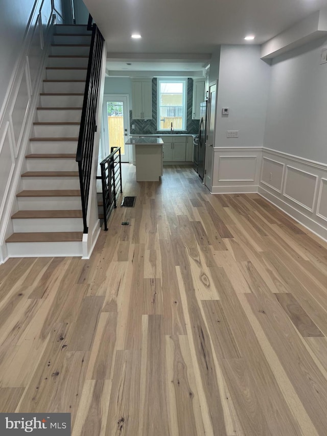 2039 S Cleveland St, Philadelphia, PA 19145 - interior space featuring a decorative wall, stairs, light wood-style floors, wainscoting, and recessed lighting