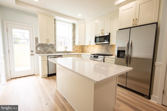 2039 S Cleveland St, Philadelphia, PA 19145 - kitchen featuring stainless steel appliances, healthy amount of natural light, light wood-type flooring, a center island, and recessed lighting