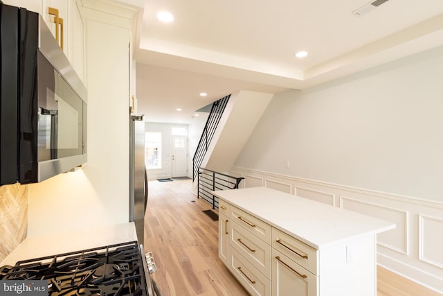 2039 S Cleveland St, Philadelphia, PA 19145 - hall with light wood finished floors, a decorative wall, wainscoting, and recessed lighting