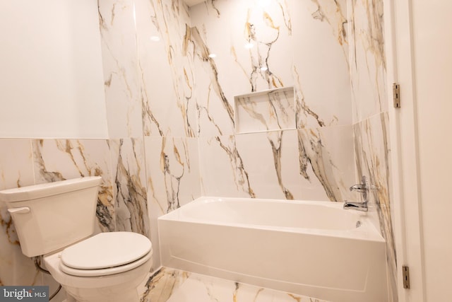 2039 S Cleveland St, Philadelphia, PA 19145 - bathroom featuring tile walls, a tub to relax in, toilet, and marble finish floors
