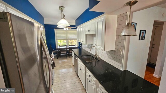 14 Curry Ln, Horsham, PA 19044 - kitchen with stainless steel appliances, a sink, decorative backsplash, white cabinets, and light wood finished floors