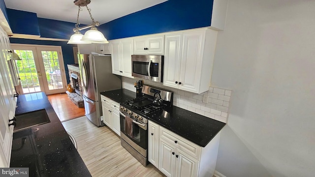14 Curry Ln, Horsham, PA 19044 - kitchen featuring stainless steel appliances, tasteful backsplash, light wood-style floors, and white cabinetry