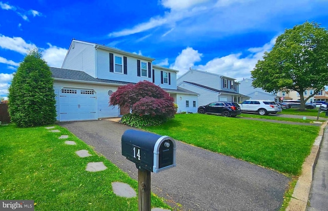 14 Curry Ln, Horsham, PA 19044 - traditional-style house with a front yard, asphalt driveway, and a garage