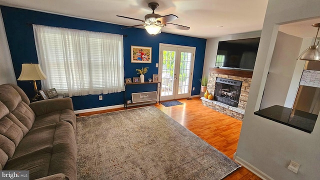 14 Curry Ln, Horsham, PA 19044 - living area featuring a stone fireplace, a ceiling fan, baseboards, wood finished floors, and french doors