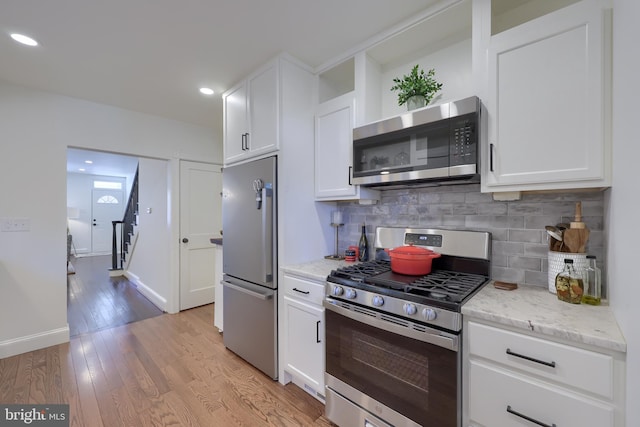 30 N Marshall St, Lancaster, PA 17602 - kitchen with stainless steel appliances, tasteful backsplash, white cabinets, light wood-style flooring, and recessed lighting