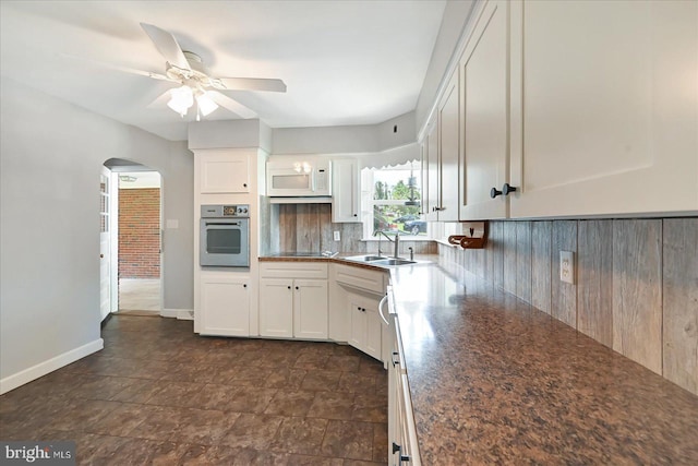 1803 Dubs Church Rd, Hanover, PA 17331 - kitchen with oven, white microwave, a sink, backsplash, and a ceiling fan