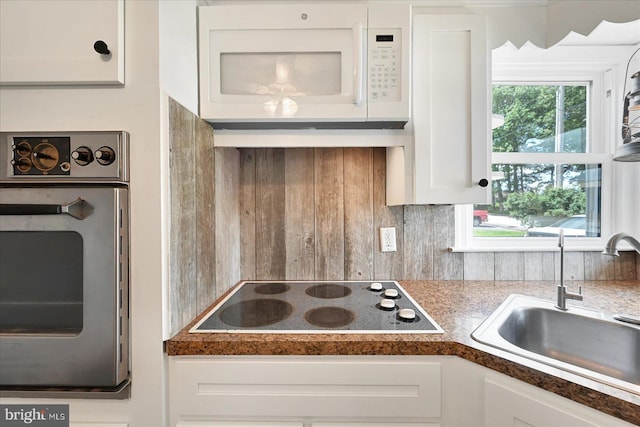 1803 Dubs Church Rd, Hanover, PA 17331 - kitchen with electric cooktop, oven, white microwave, a sink, and white cabinetry