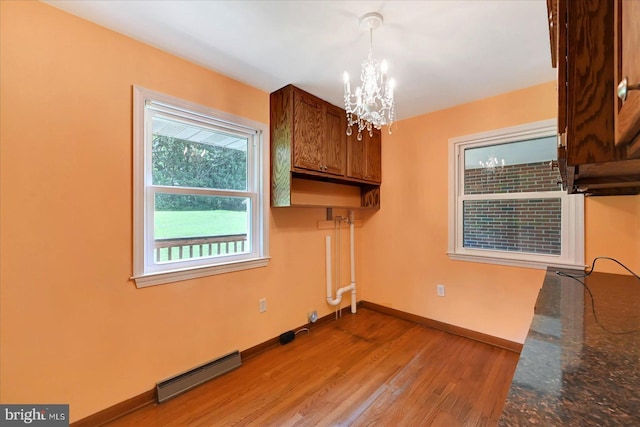 1803 Dubs Church Rd, Hanover, PA 17331 - unfurnished dining area featuring baseboards, a chandelier, light wood-type flooring, and baseboard heating