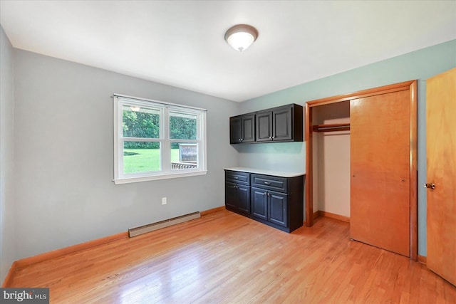 1803 Dubs Church Rd, Hanover, PA 17331 - unfurnished bedroom featuring a baseboard heating unit, light wood finished floors, a closet, and baseboards
