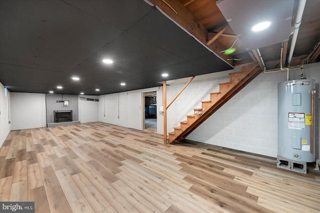 1803 Dubs Church Rd, Hanover, PA 17331 - finished basement with electric water heater, stairway, wood finished floors, a brick fireplace, and recessed lighting