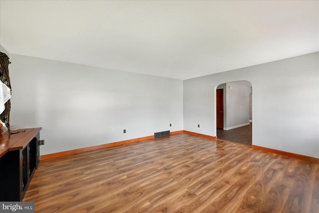 1803 Dubs Church Rd, Hanover, PA 17331 - unfurnished living room featuring arched walkways, wood finished floors, and baseboards