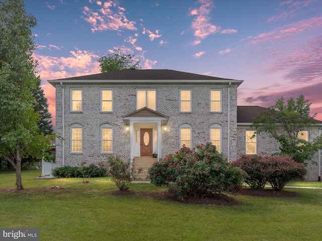 9486 Broadlands Ln, Nokesville, VA 20181 - georgian-style home featuring a lawn and brick siding