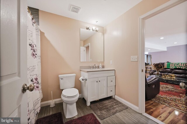 5544 Old Colony Ct, White Plains, MD 20695 - full bath featuring wood finished floors, vanity, toilet, baseboards, and recessed lighting