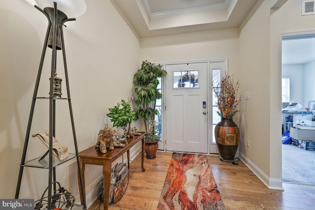 5544 Old Colony Ct, White Plains, MD 20695 - foyer entrance featuring wood finished floors, ornamental molding, a tray ceiling, and baseboards