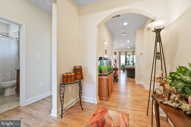 5544 Old Colony Ct, White Plains, MD 20695 - hall with arched walkways, light wood-style flooring, baseboards, and recessed lighting