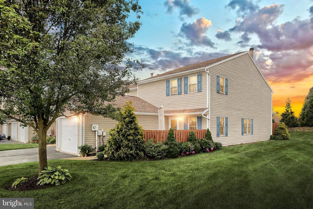 701 Stonegate Ct, York, PA 17408 - view of front of house with asphalt driveway, a lawn, an attached garage, and a chimney