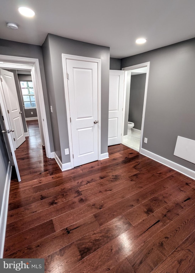 1512 W Pratt St, Baltimore, MD 21223 - unfurnished bedroom featuring baseboards, dark wood-type flooring, recessed lighting, and connected bathroom
