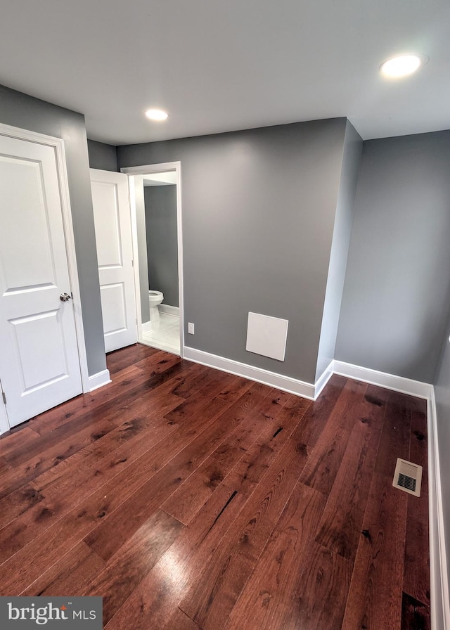 1512 W Pratt St, Baltimore, MD 21223 - unfurnished bedroom with dark wood-type flooring, recessed lighting, baseboards, and connected bathroom