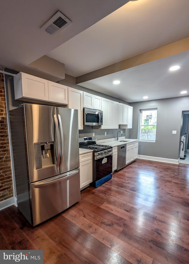 1512 W Pratt St, Baltimore, MD 21223 - kitchen with stainless steel appliances, a sink, white cabinetry, light countertops, and recessed lighting