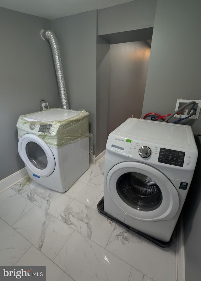 1512 W Pratt St, Baltimore, MD 21223 - laundry area featuring washer / dryer, light marble finish flooring, and baseboards