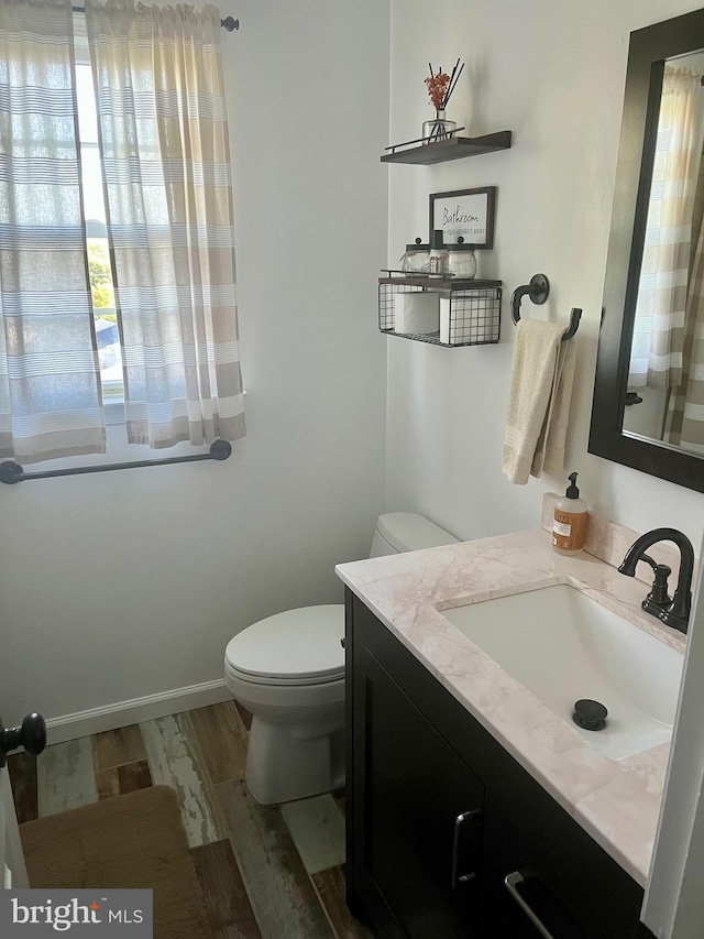 19 Zanella Dr, Emmitsburg, MD 21727 - bathroom featuring toilet, vanity, wood finished floors, and baseboards