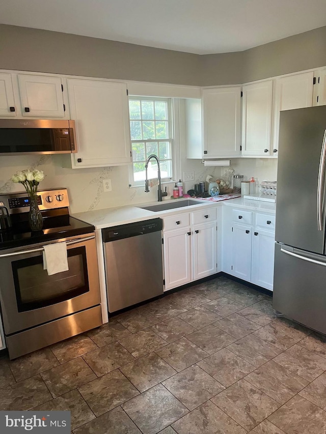 19 Zanella Dr, Emmitsburg, MD 21727 - kitchen featuring stainless steel appliances, white cabinetry, light countertops, and dark stone finish floors
