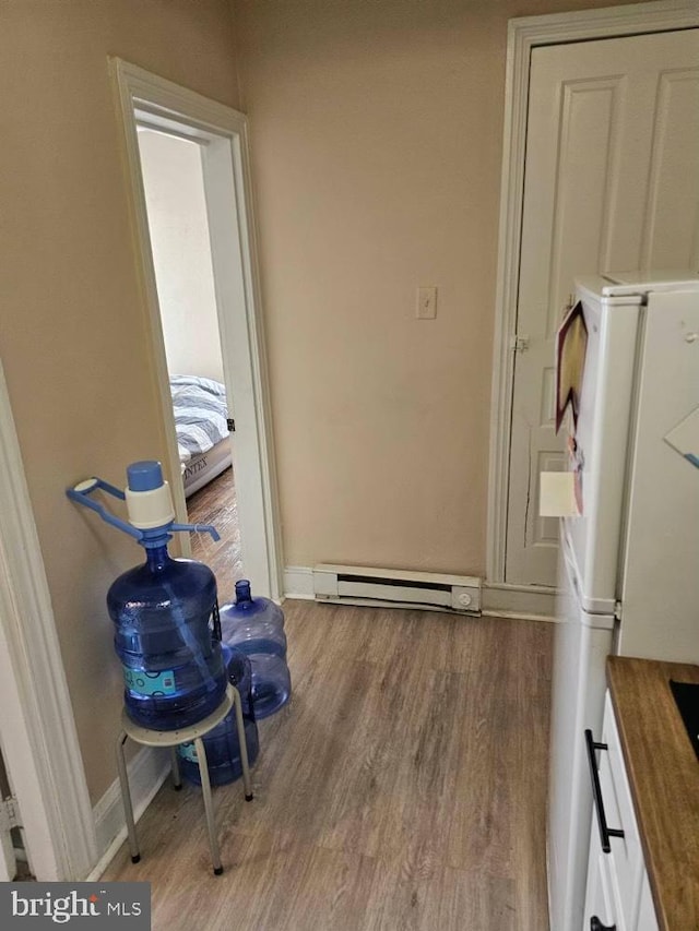 236 N Charlotte St, Pottstown, PA 19464 - doorway to outside featuring wood finished floors, a baseboard heating unit, and baseboards