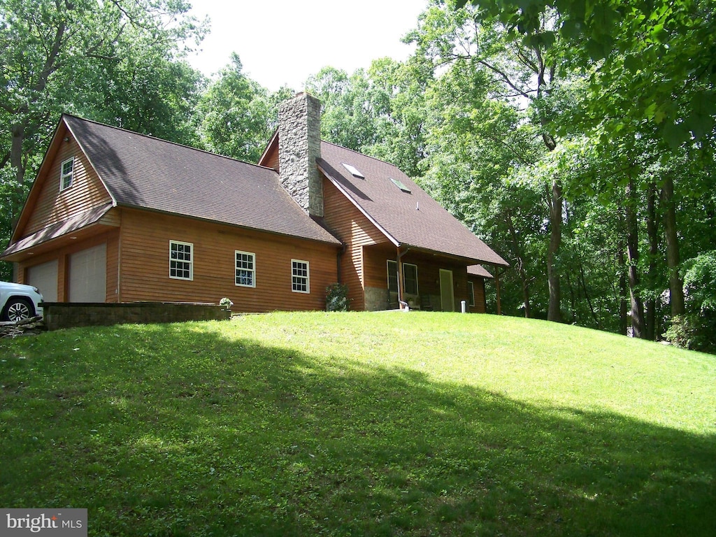 199 Wilson Rd, Quarryville, PA 17566 - view of side of home with a chimney and a yard