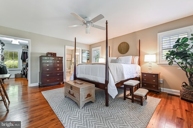 205 Mallard Dr, Stevensville, MD 21666 - bedroom featuring hardwood / wood-style flooring, a spacious closet, ensuite bath, a closet, and a ceiling fan
