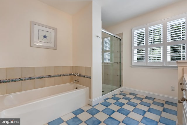 205 Mallard Dr, Stevensville, MD 21666 - bathroom featuring a garden tub, a shower stall, vanity, and baseboards