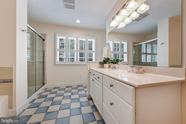 205 Mallard Dr, Stevensville, MD 21666 - bathroom with vanity, a shower stall, tile patterned floors, baseboards, and a tub to relax in