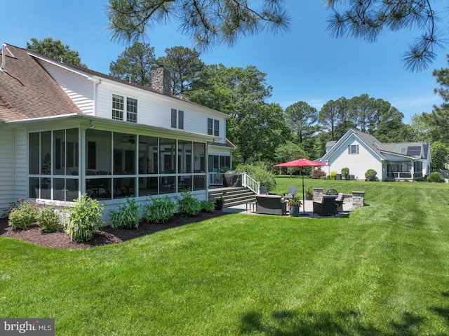 205 Mallard Dr, Stevensville, MD 21666 - view of green lawn featuring a sunroom and an outdoor hangout area