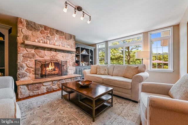 205 Mallard Dr, Stevensville, MD 21666 - living area with a fireplace, healthy amount of natural light, and light wood-type flooring