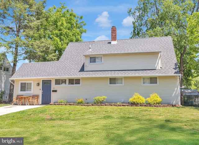 15 Wildflower Rd, Levittown, PA 19057 - view of front of home with a front yard, a chimney, and a shingled roof
