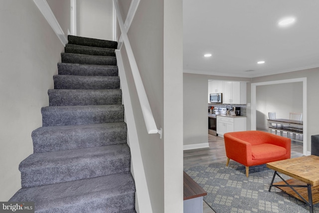 15 Wildflower Rd, Levittown, PA 19057 - staircase with crown molding, recessed lighting, wood finished floors, and baseboards