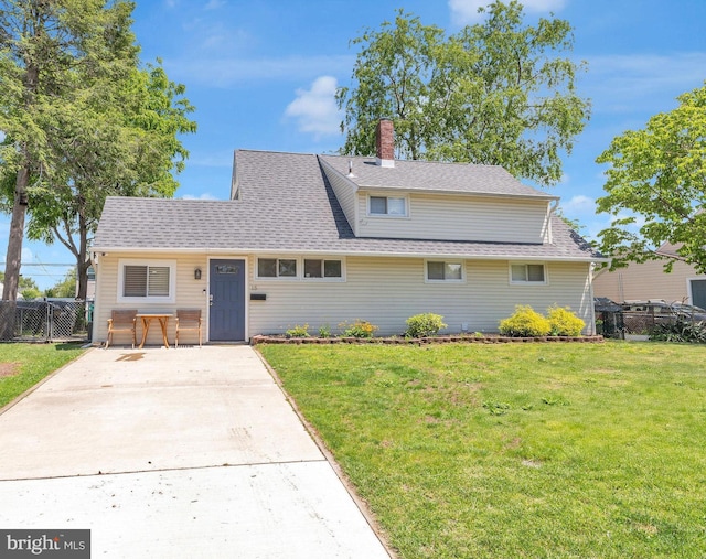 15 Wildflower Rd, Levittown, PA 19057 - view of front of house with a shingled roof and a chimney