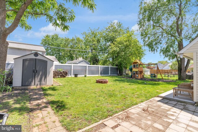 15 Wildflower Rd, Levittown, PA 19057 - view of yard with an outdoor fire pit, a playground, and a patio